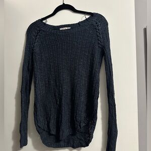 Navy blue sweater with braided details on the arms